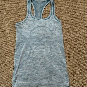 Lululemon Swiftly racerback tech tank top women Size 4. Light blue gently worn